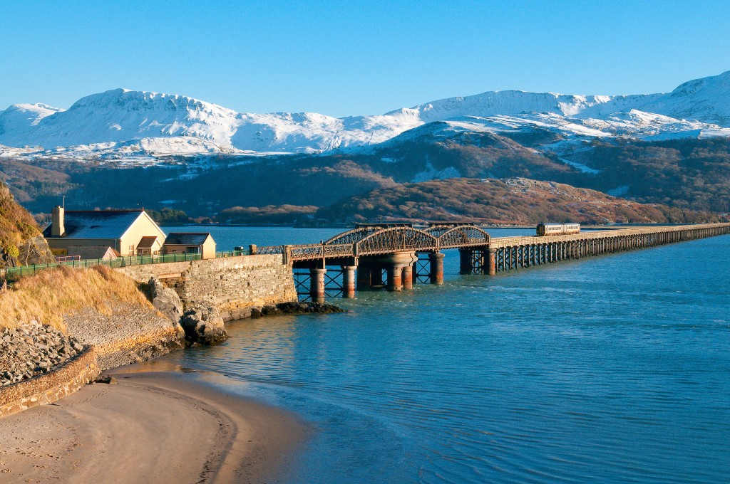 Barmouth Bridge View to Tyrau Mawr in snow Mawddach estuary Gwynedd ...